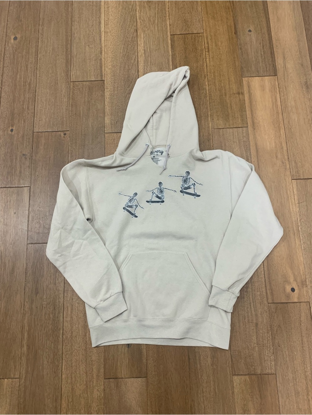 Men's Light Cream Pullover Hoodie with Skateboard Skeleton Graphic